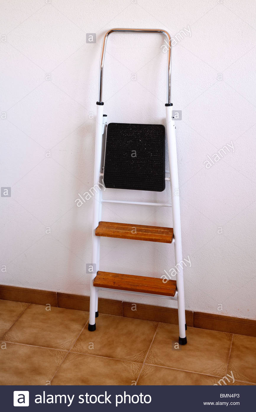 closed step ladder leaning against inside wall Stock Photo, Royalty