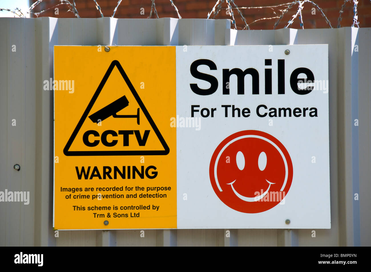 CCTV warning sign with humourous 'smile for the camera' graphic. On