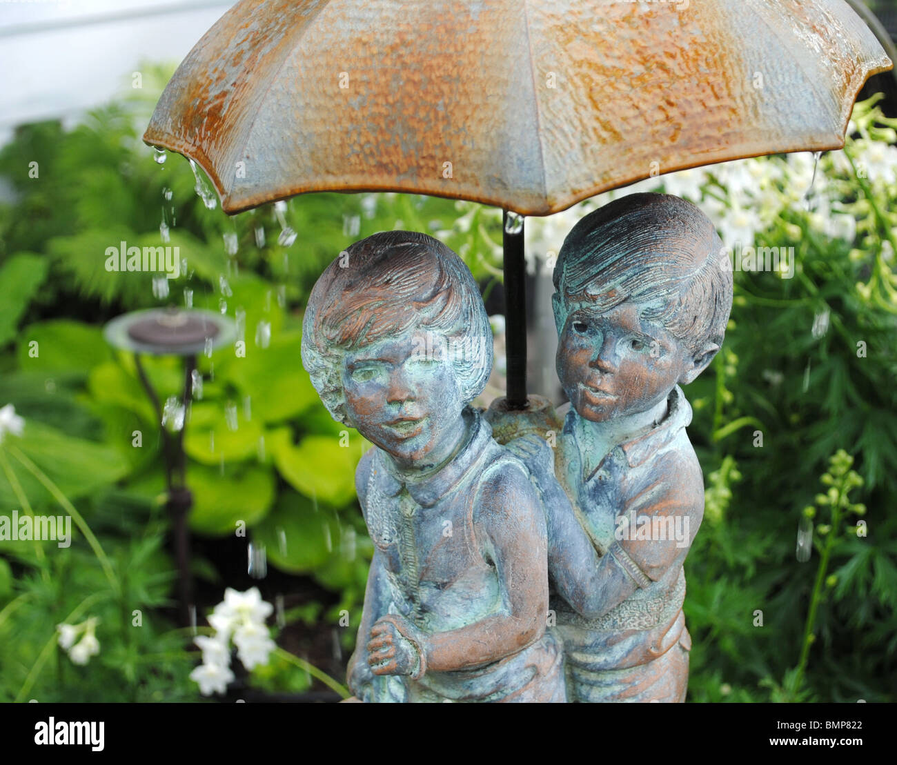 Garden Water Fountain Boy and Girl Under Umbrella Stock Photo, Royalty