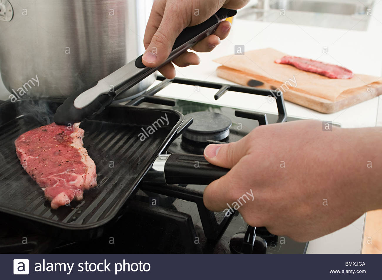 Man cooking steak on griddle Stock Photo, Royalty Free Image 30088698