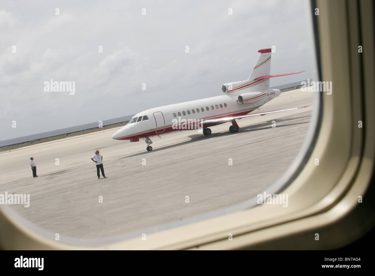 Private jet plane sitting on runway tarmac at airport Stock Photo