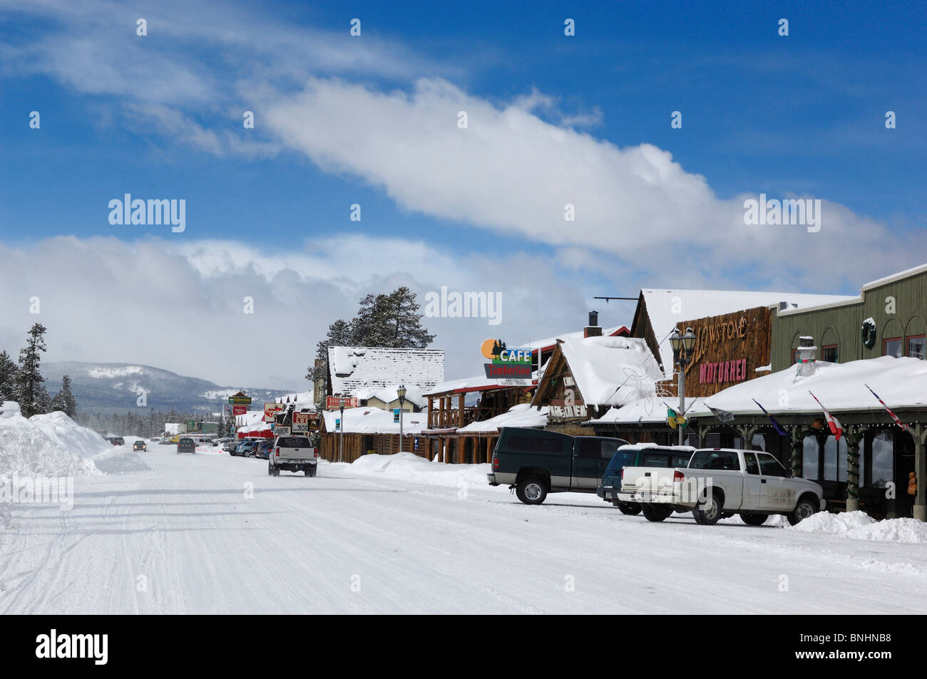 USA West Yellowstone Winter Montana village small town snow cars Stock