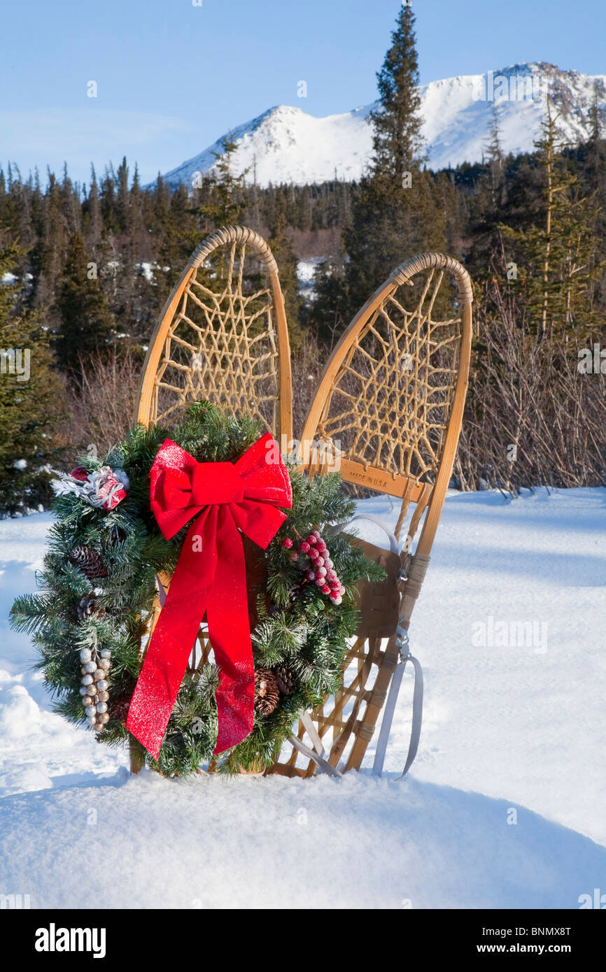 Trapperstyle wooden snowshoes in snow and decorated with a Christmas