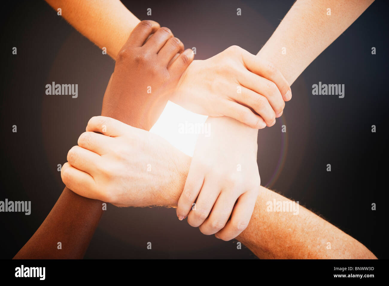 Four hands holding wrists of other people Stock Photo, Royalty Free