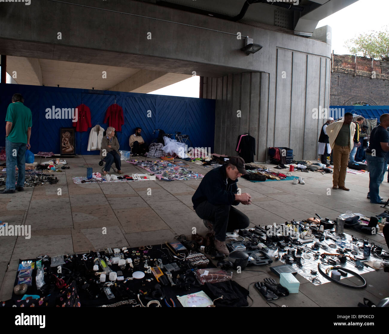 People selling small items at a weekly improvised street sale in Stock
