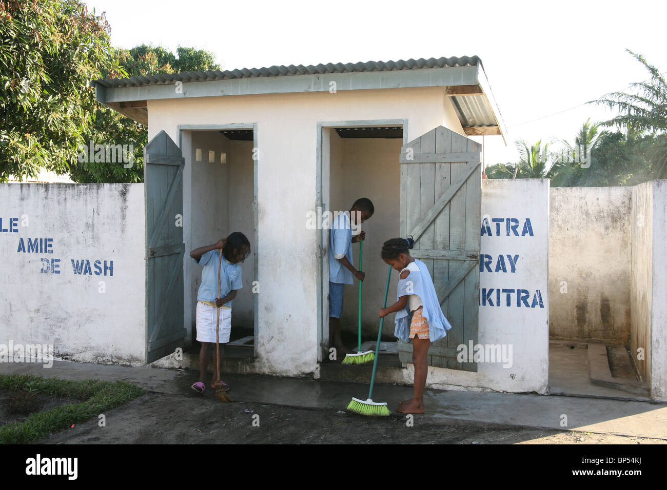 Children clean the latrines at school as part of water and sanitation