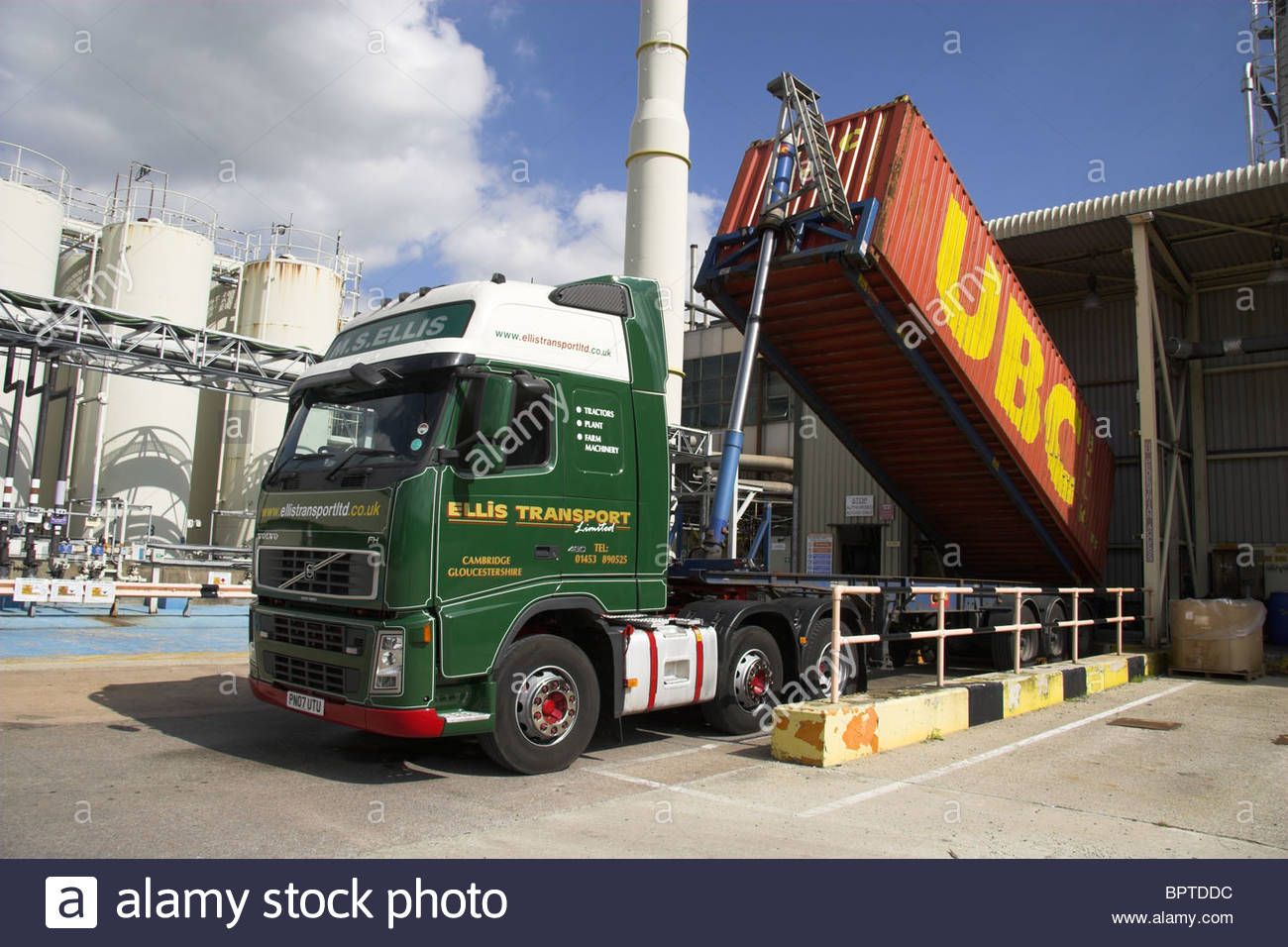 Tipping container lorry at its unloading point, discharging a load of