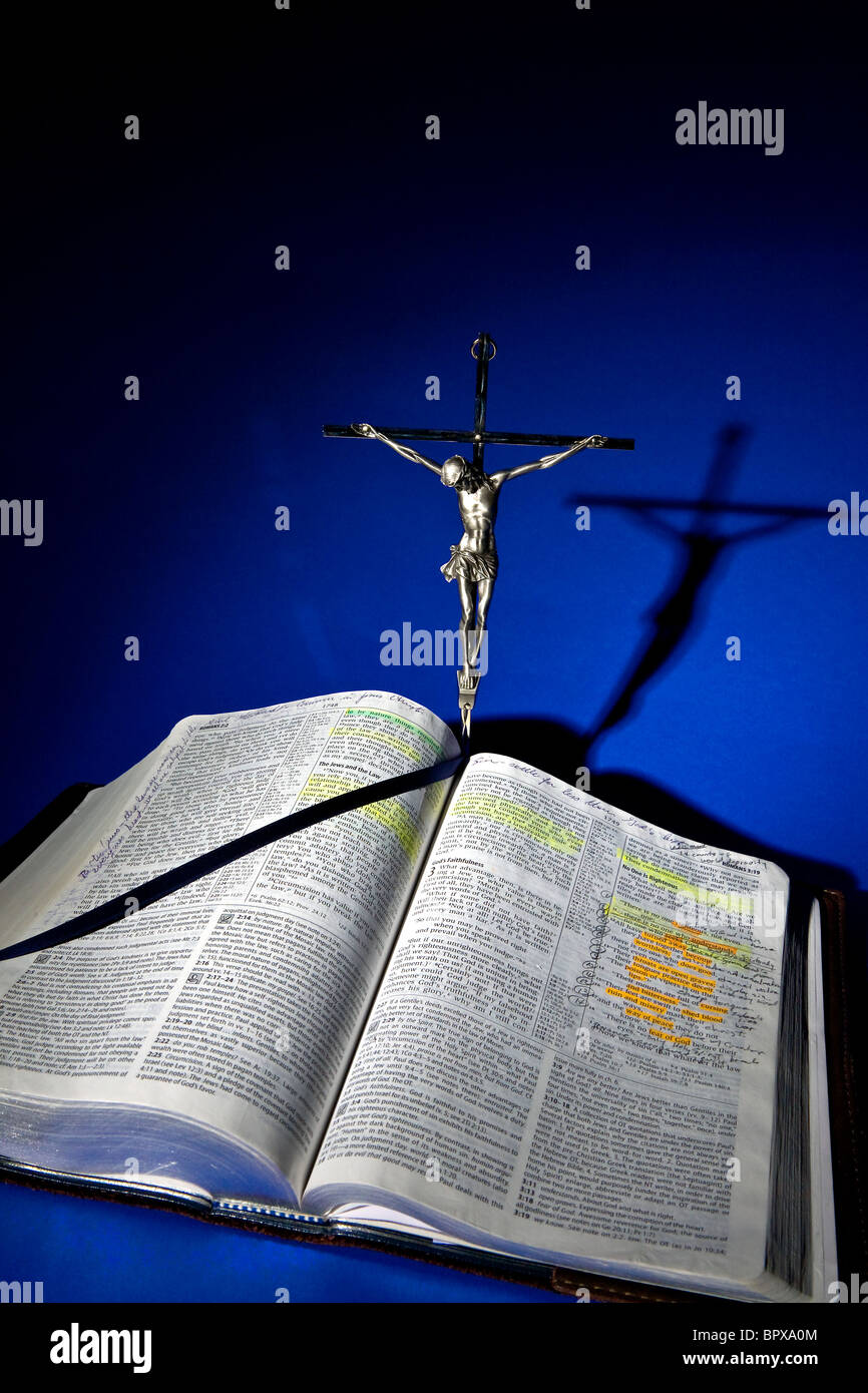 Statue Of Jesus Christ On The Cross At The Top Of An Open Bible