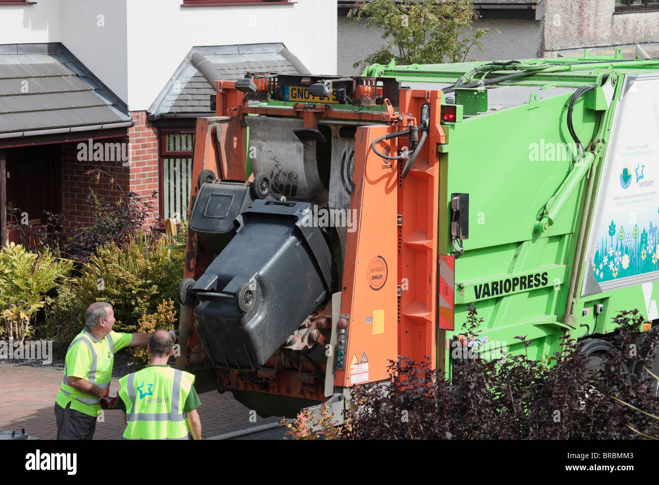Wales, UK, Britain. Bin men emptying household rubbish from wheelie Stock Photo, Royalty Free
