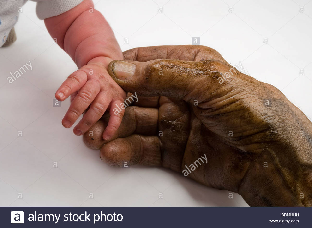an-elderly-man-holds-the-hand-of-his-newborn-granddaughter-BRMHHH.jpg