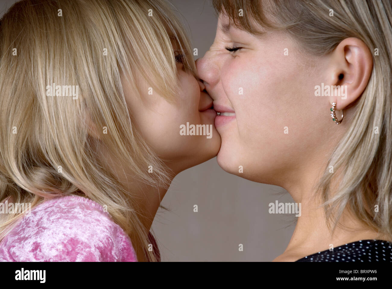 Mom kissing daughter