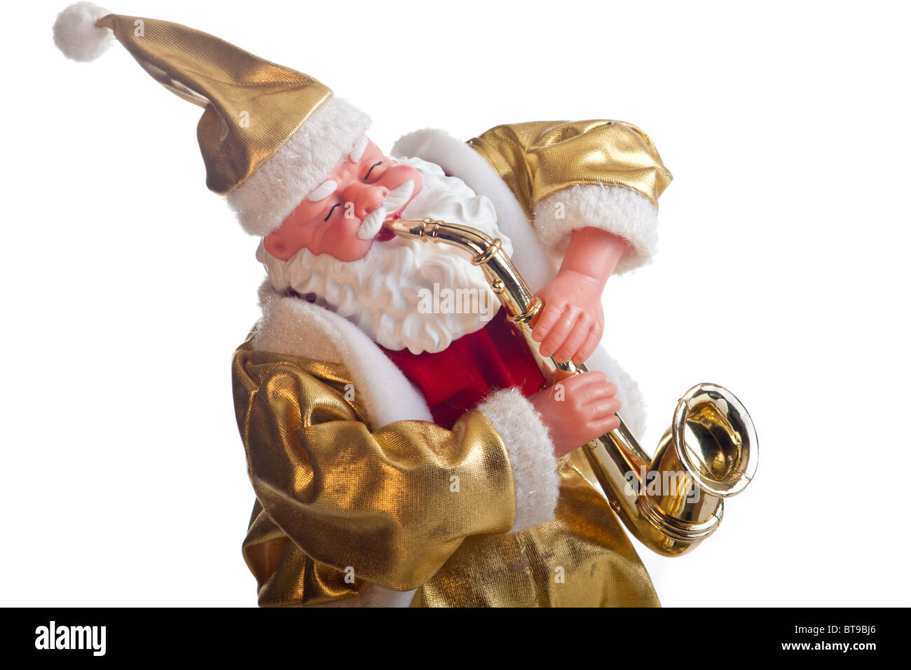santa claus figure dressed in gold plays the saxophone isolated on Stock Photo, Royalty Free