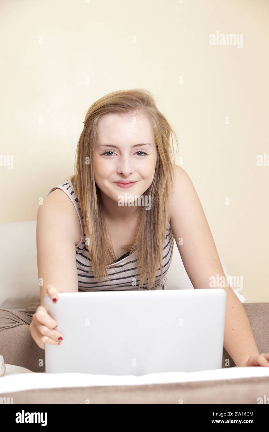a teenage girl works on a laptop computer in her bedroom uk stock teenage works