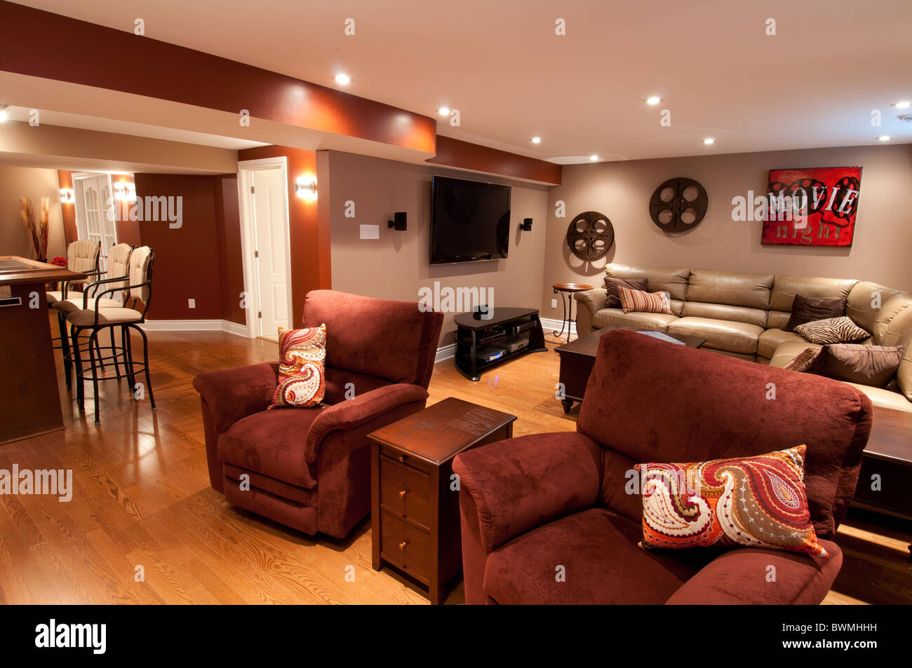 Basement in luxury residential home with sofa and television Stock
