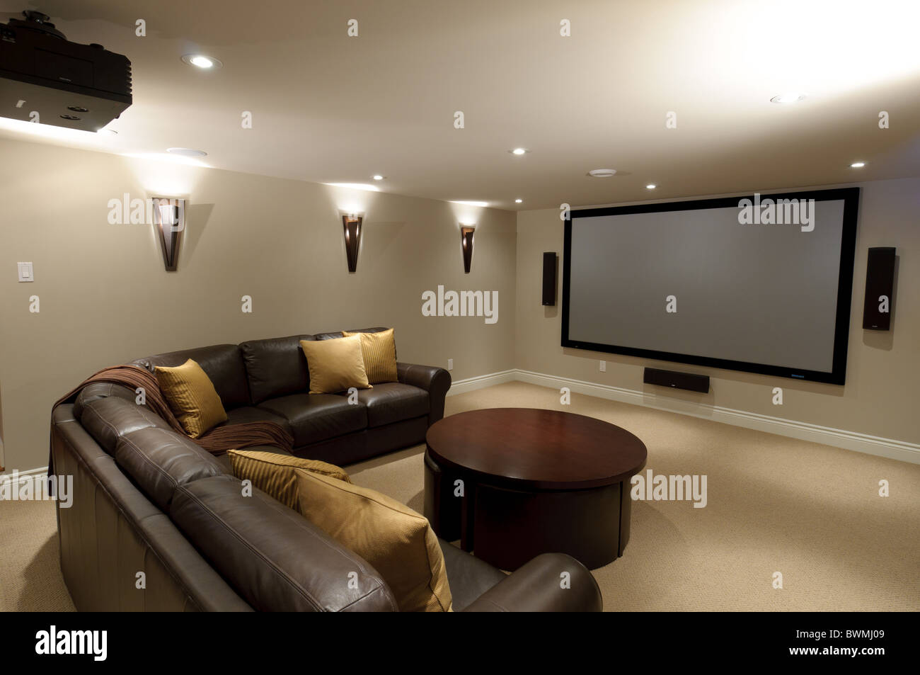 Basement in luxury residential home with sofa and television Stock