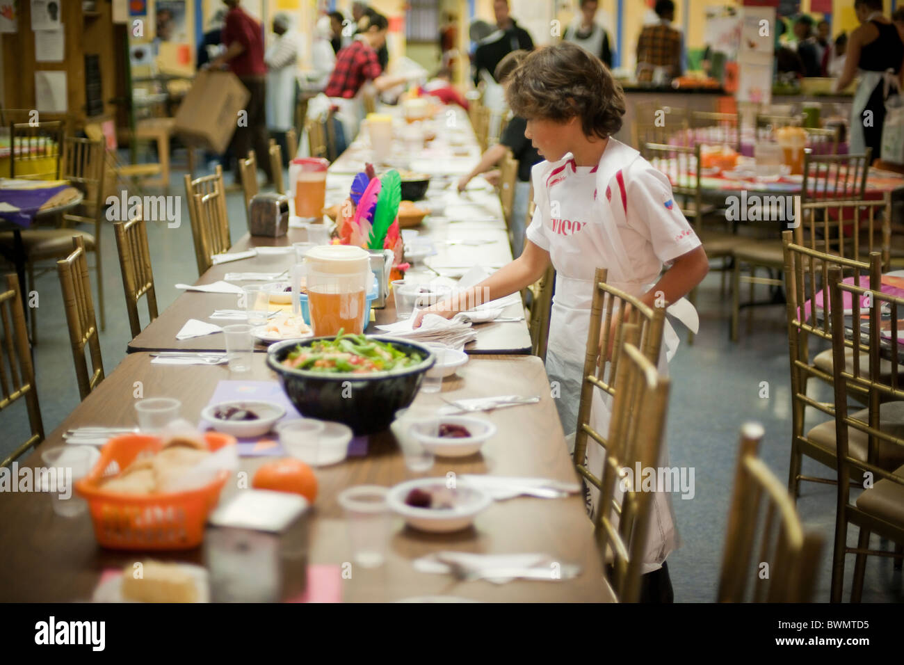 Volunteers prepare and serve Thanksgiving dinner to the ...