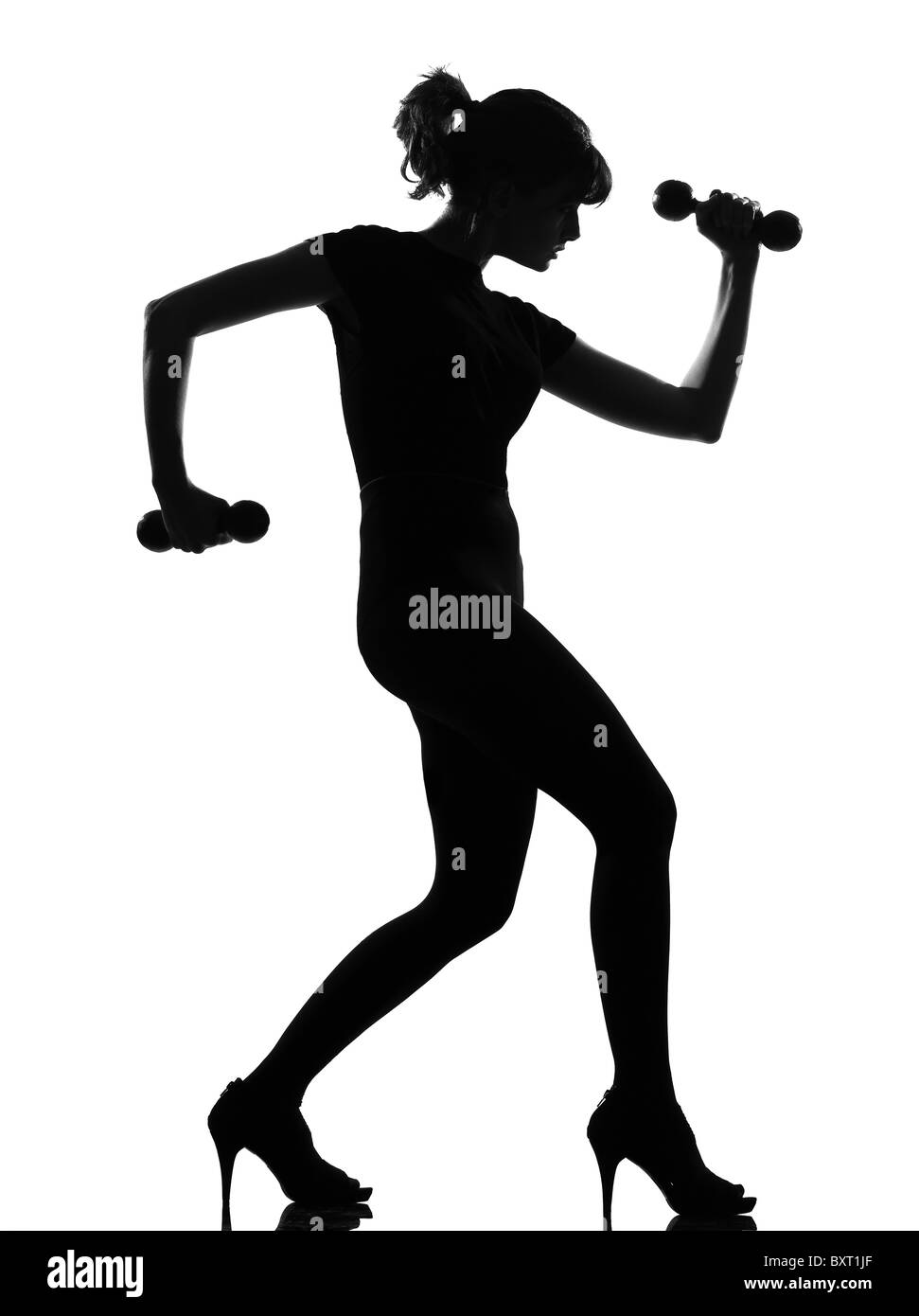 full length silhouette in shadow of a young woman workout