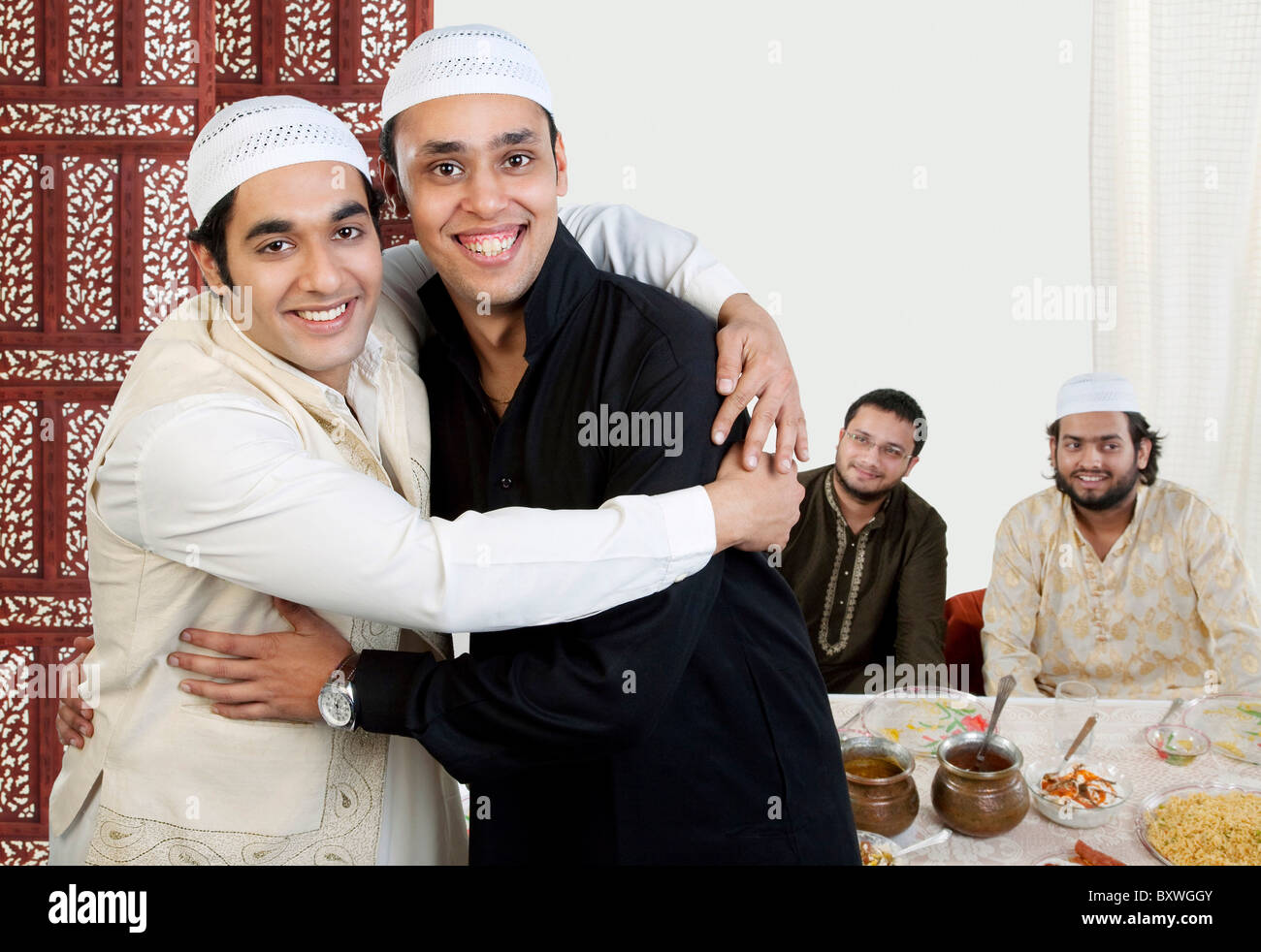 muslim-men-hugging-each-other-BXWGGY.jpg