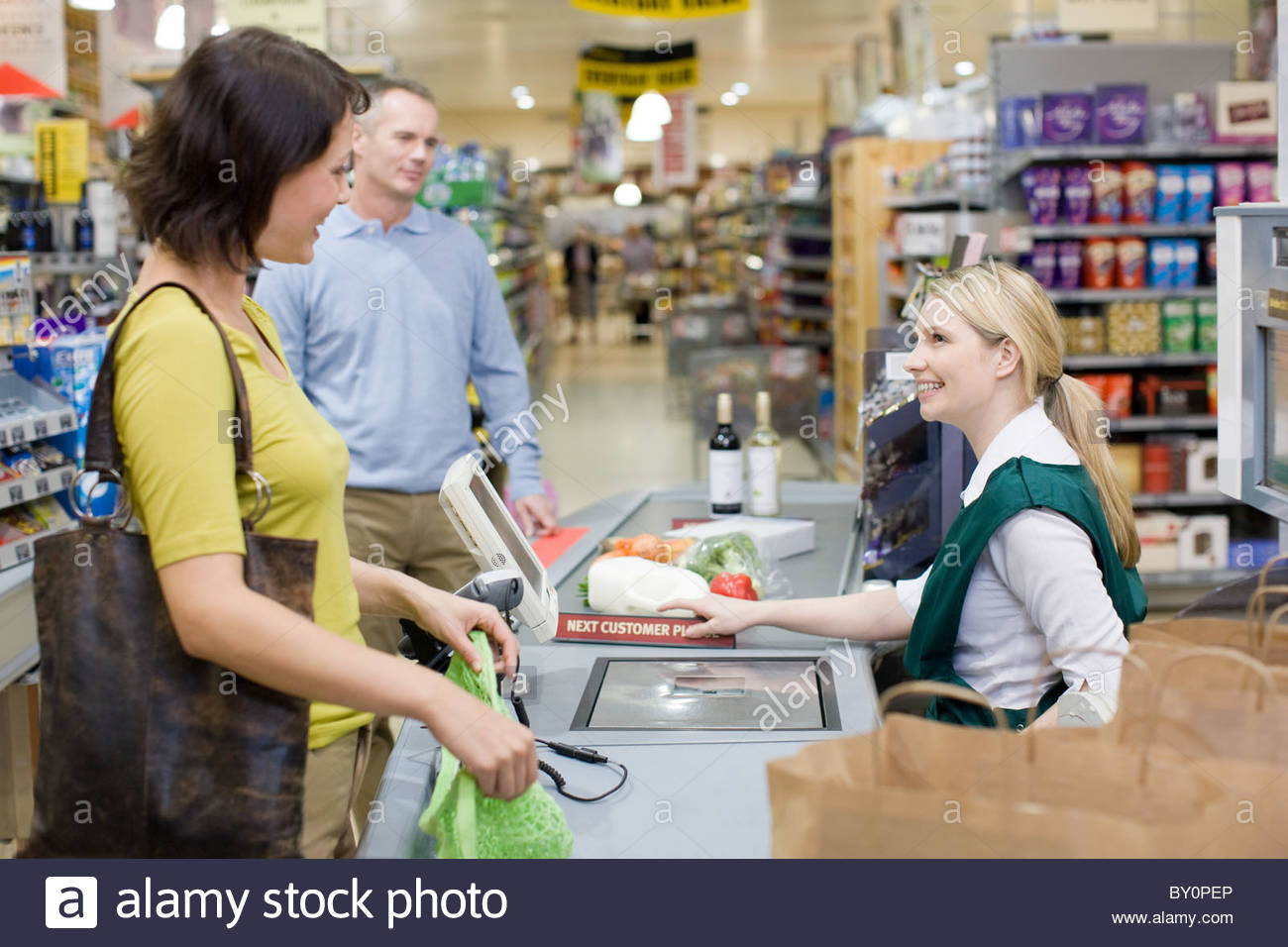 Cashier and customers at supermarket checkout Stock Photo 33823742 Alamy