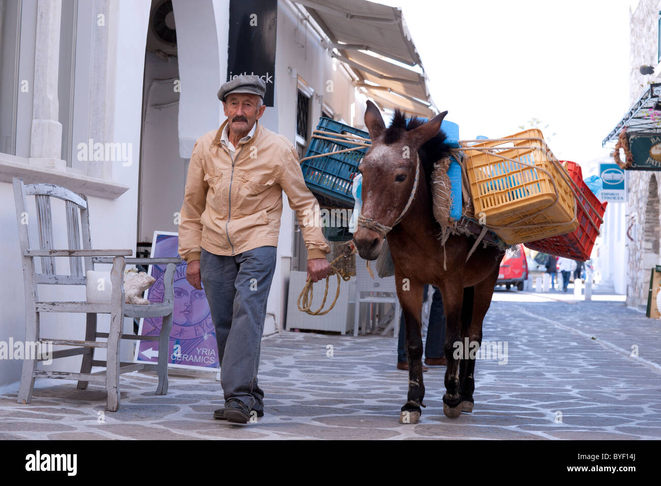 a-greek-man-leads-a-donkey-carrying-case