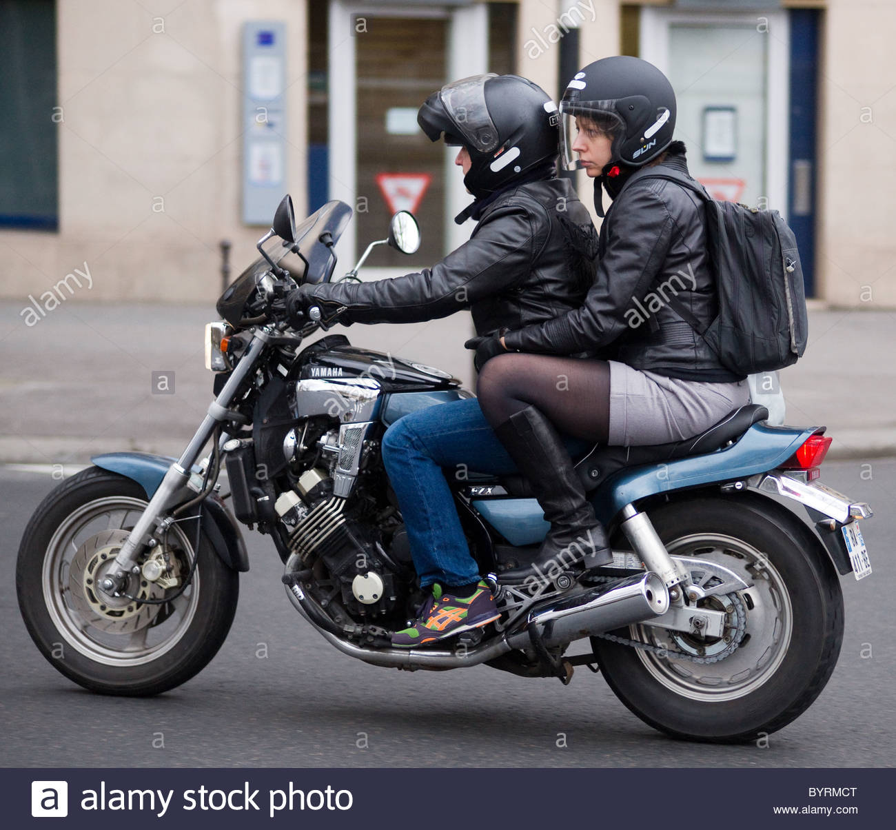 Couple together riding motorbike in Paris France Stock Photo, Royalty