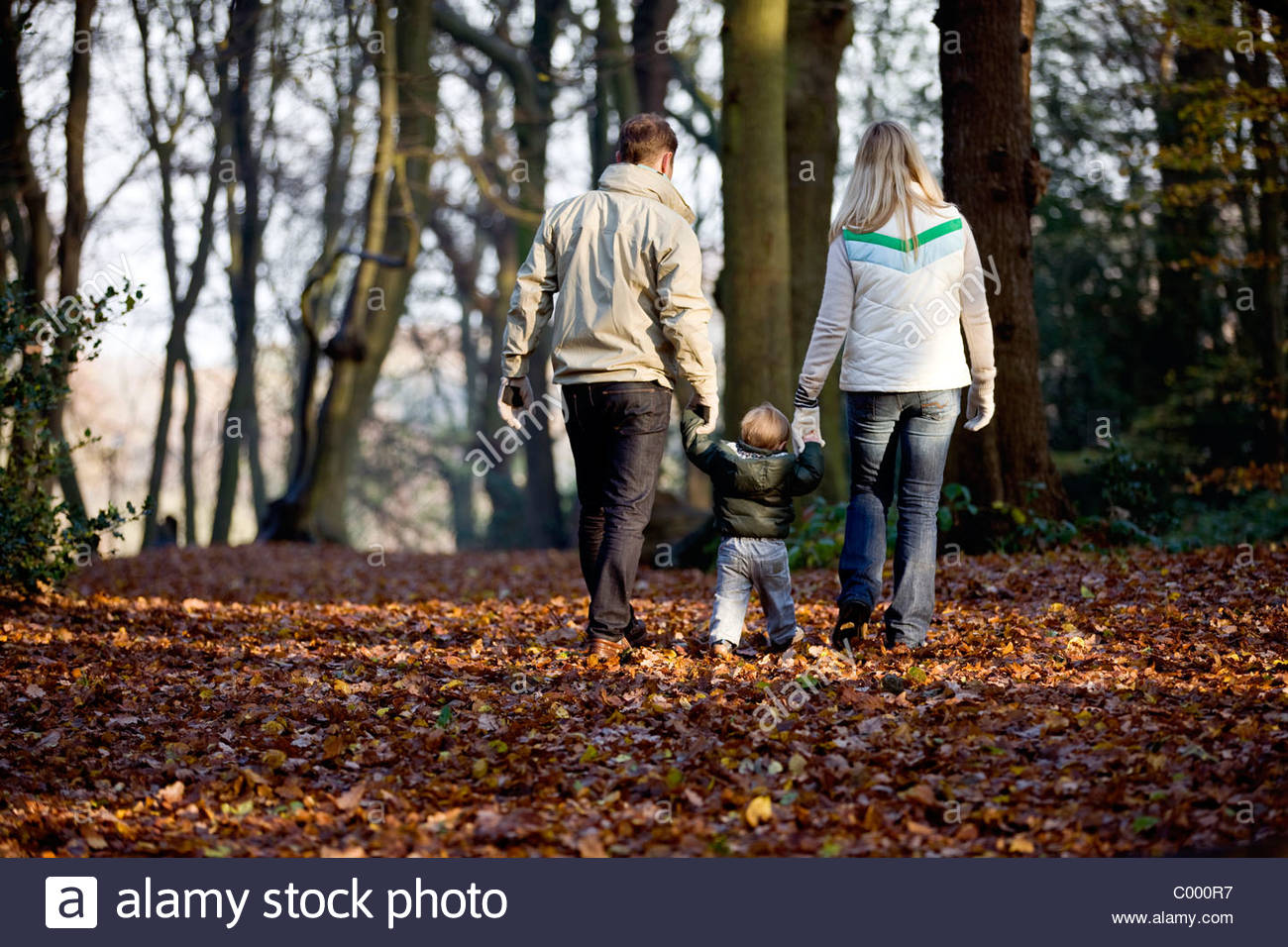 a-young-couple-walking-with-their-son-in