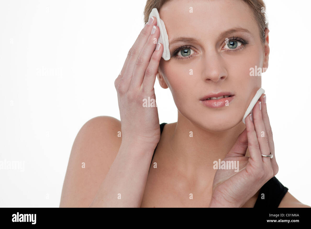 Blonde woman removing make up with <b>cotton wool</b> pads Stock Photo - blonde-woman-removing-make-up-with-cotton-wool-pads-C01M6A