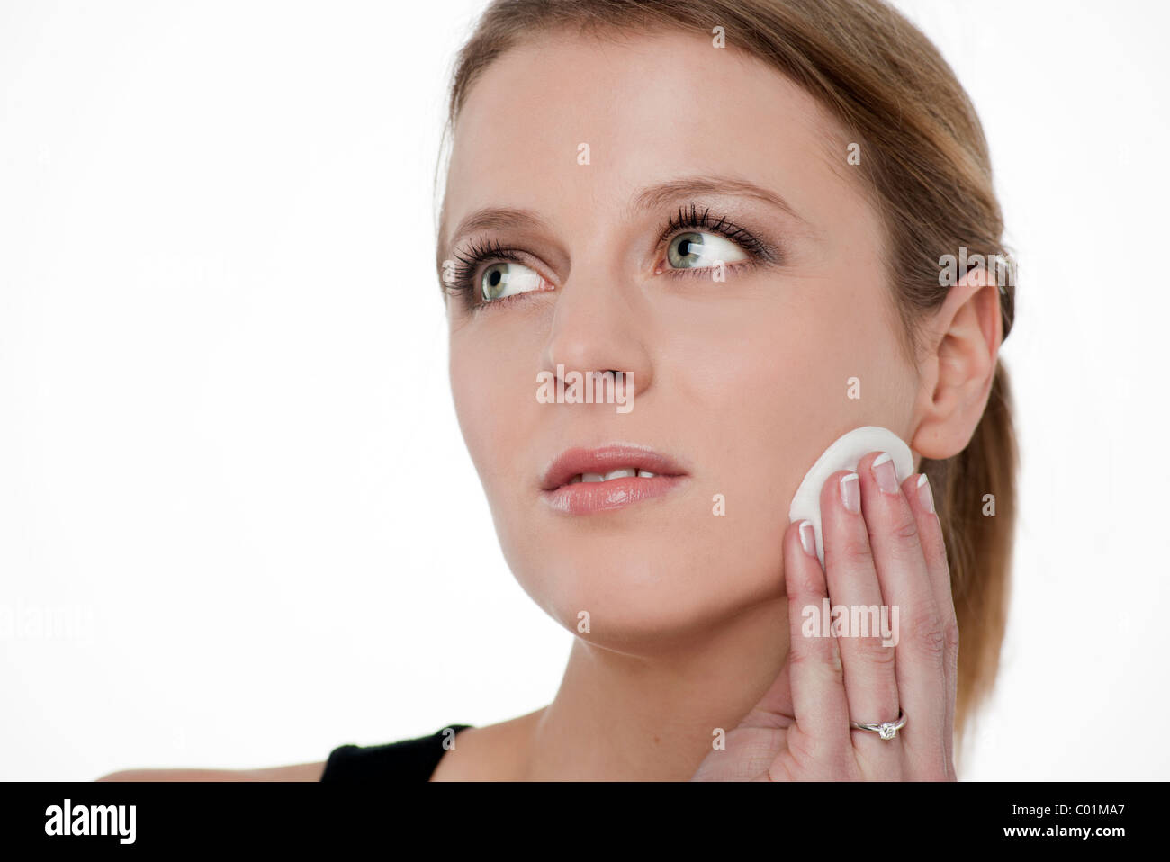 Blonde woman removing make up from the face using <b>cotton wool</b> pad Stock <b>...</b> - blonde-woman-removing-make-up-from-the-face-using-cotton-wool-pad-C01MA7