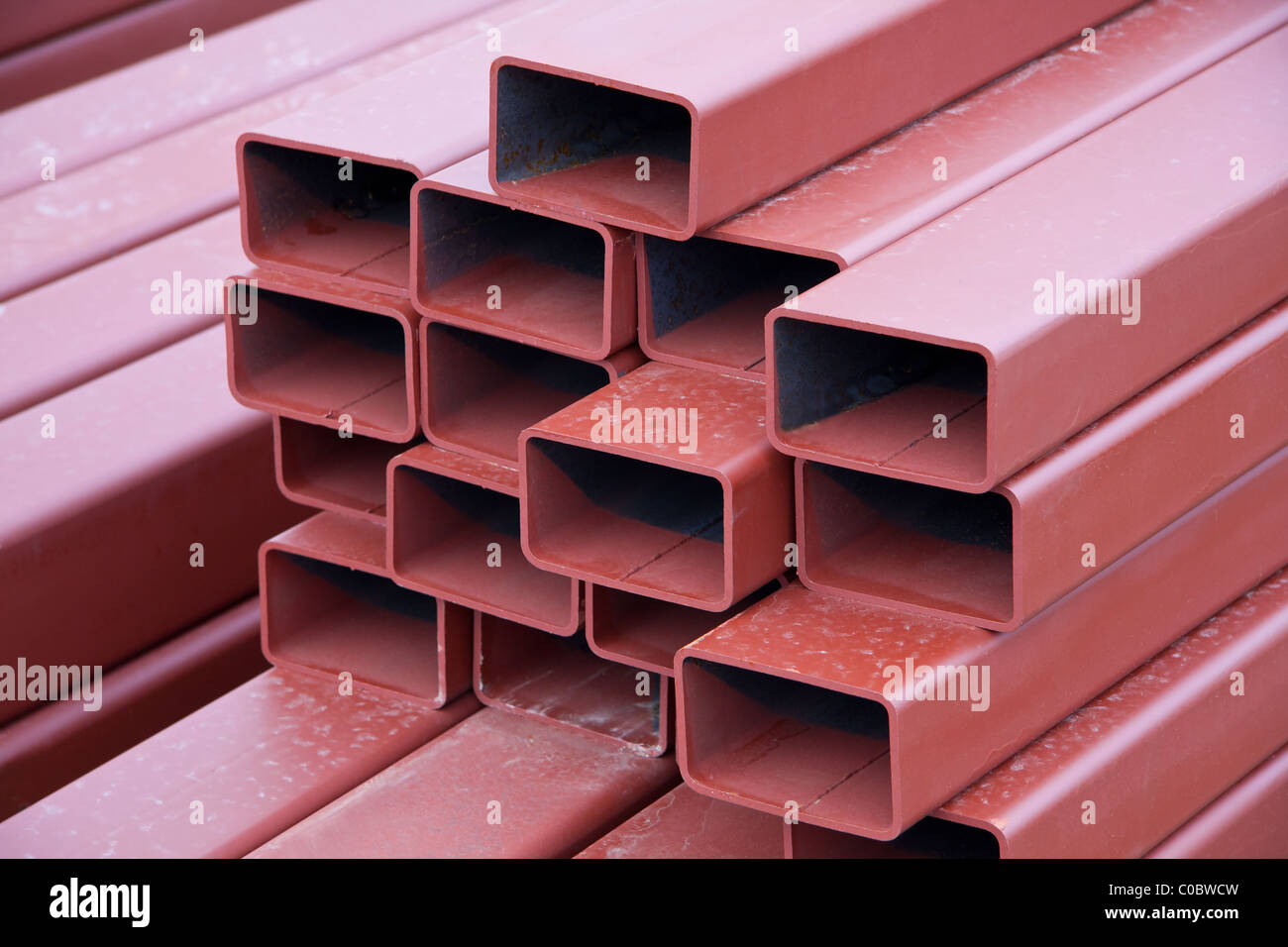 A stack of painted steel beams used in construction Stock Photo