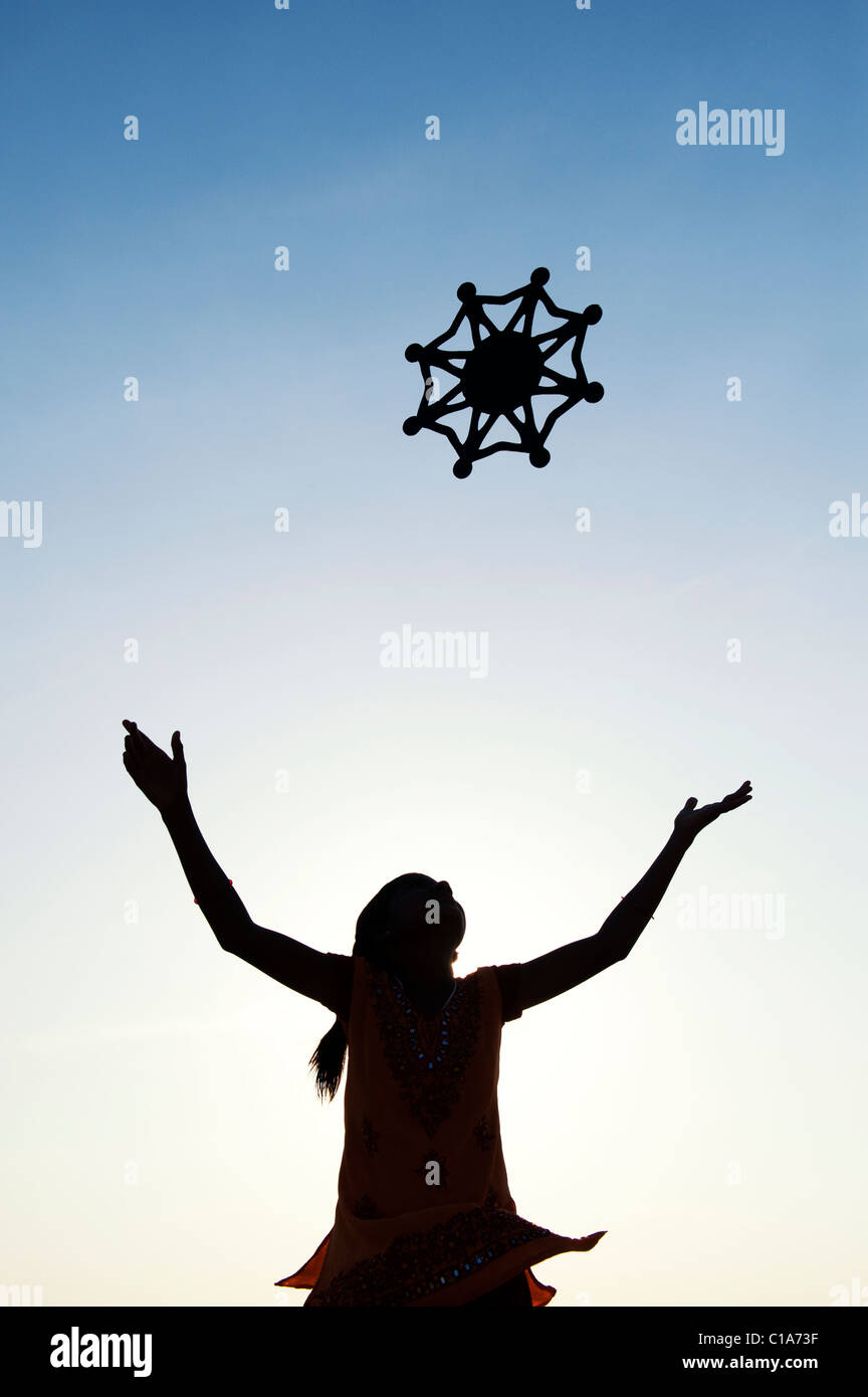 Silhouette indian girl throwing a symbol of one world, unity and Stock Photo, Royalty Free Image