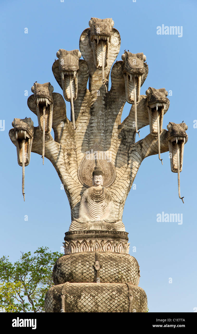 Statue of Seated Buddha Meditating Under Naga in the Sala Kaew Ku Stock