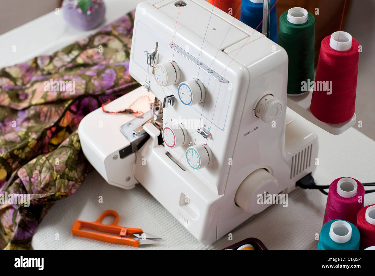 Serger on table sewing fabric Stock Photo, Royalty Free Image: 35620418
