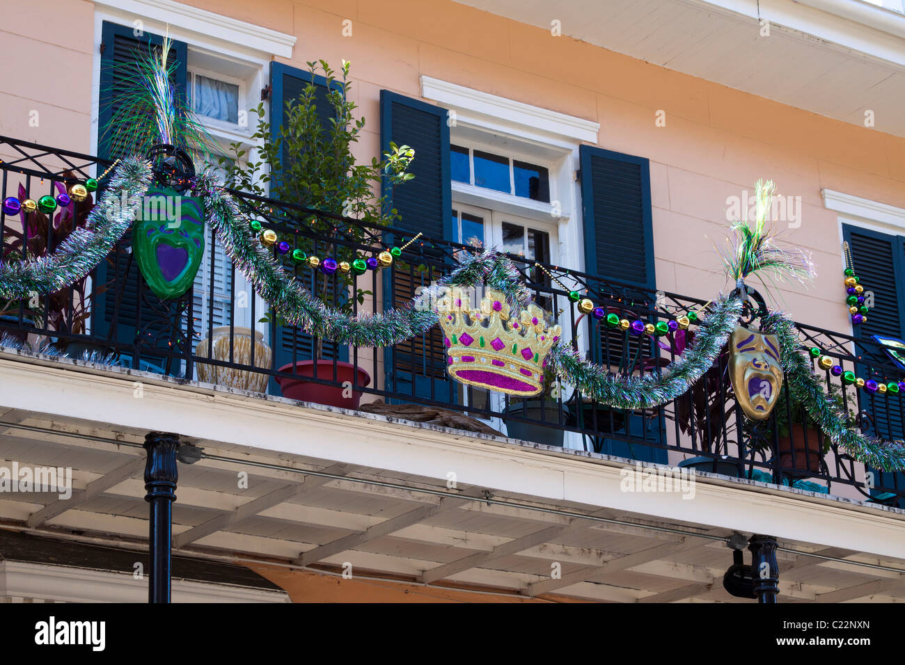 New Orleans wrought iron balcony decorated for Mardi Gras with crown