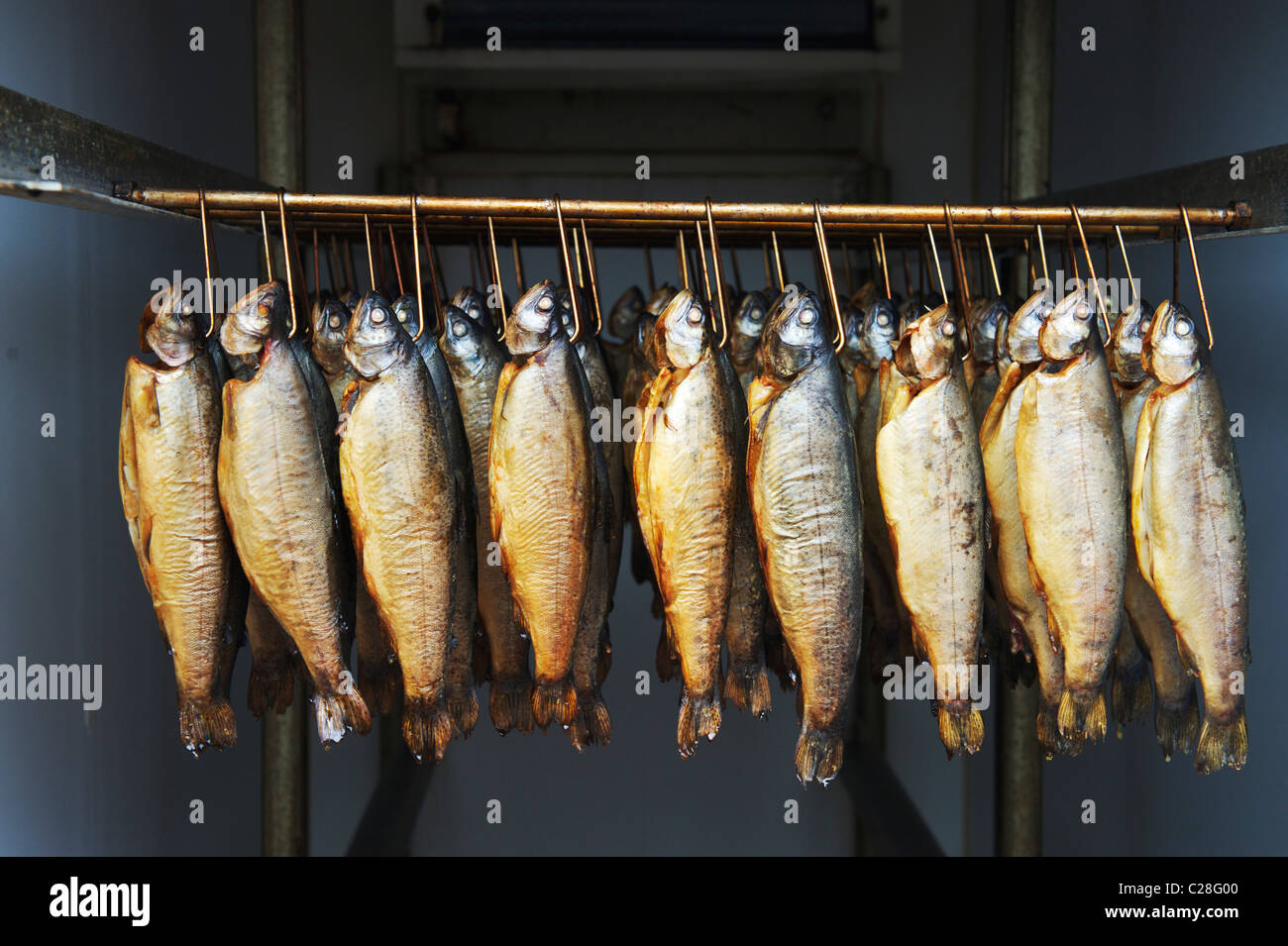 smoked fish hanging in a smokehouse in Suffolk Stock Photo, Royalty