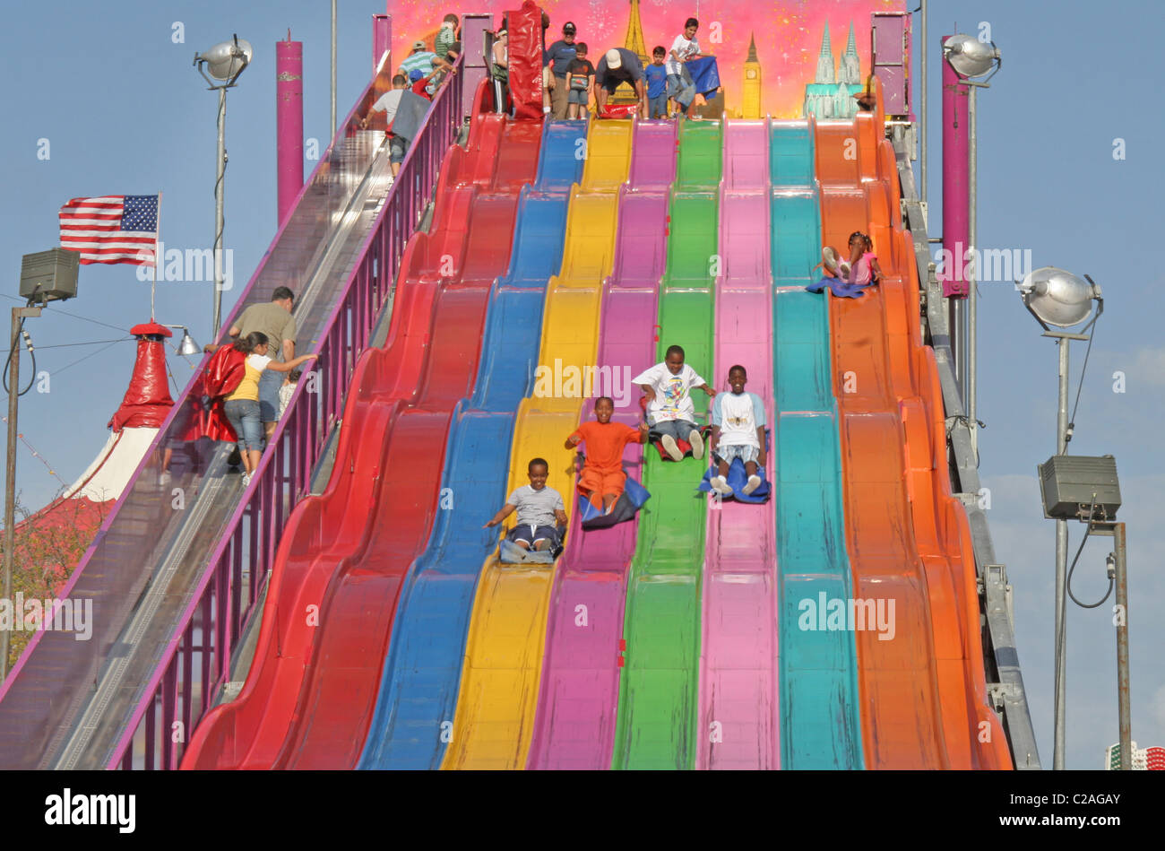 Ethnic kids down giant slide at Miami Dade County Fair Miami Florida