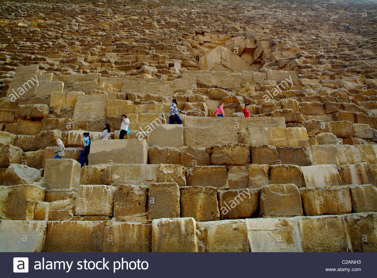 Tourists climbing the Great Pyramid of Khufu in Giza, Egypt Stock Photo
