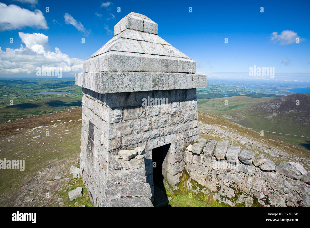 Stone shelter at the summit of Slieve Meelmore, Mourne Mountains Stock