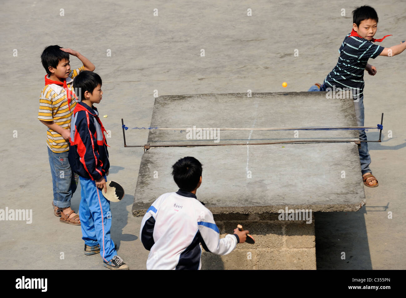 Chinese primary school students play table tennis in remote Stock Photo