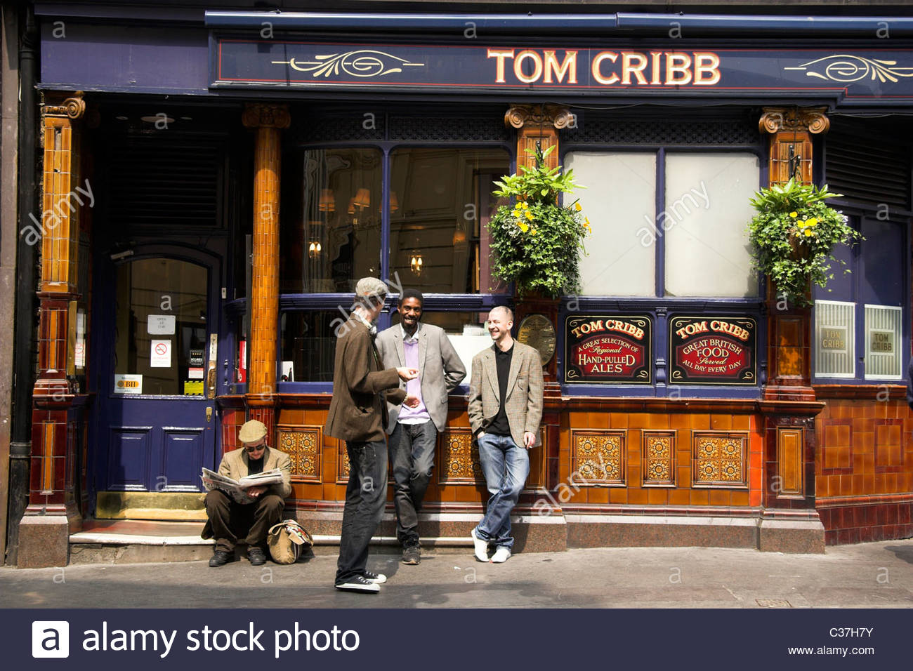 Smokers outside the Tom Cribb pub in Piccadilly, London, UK Stock Photo