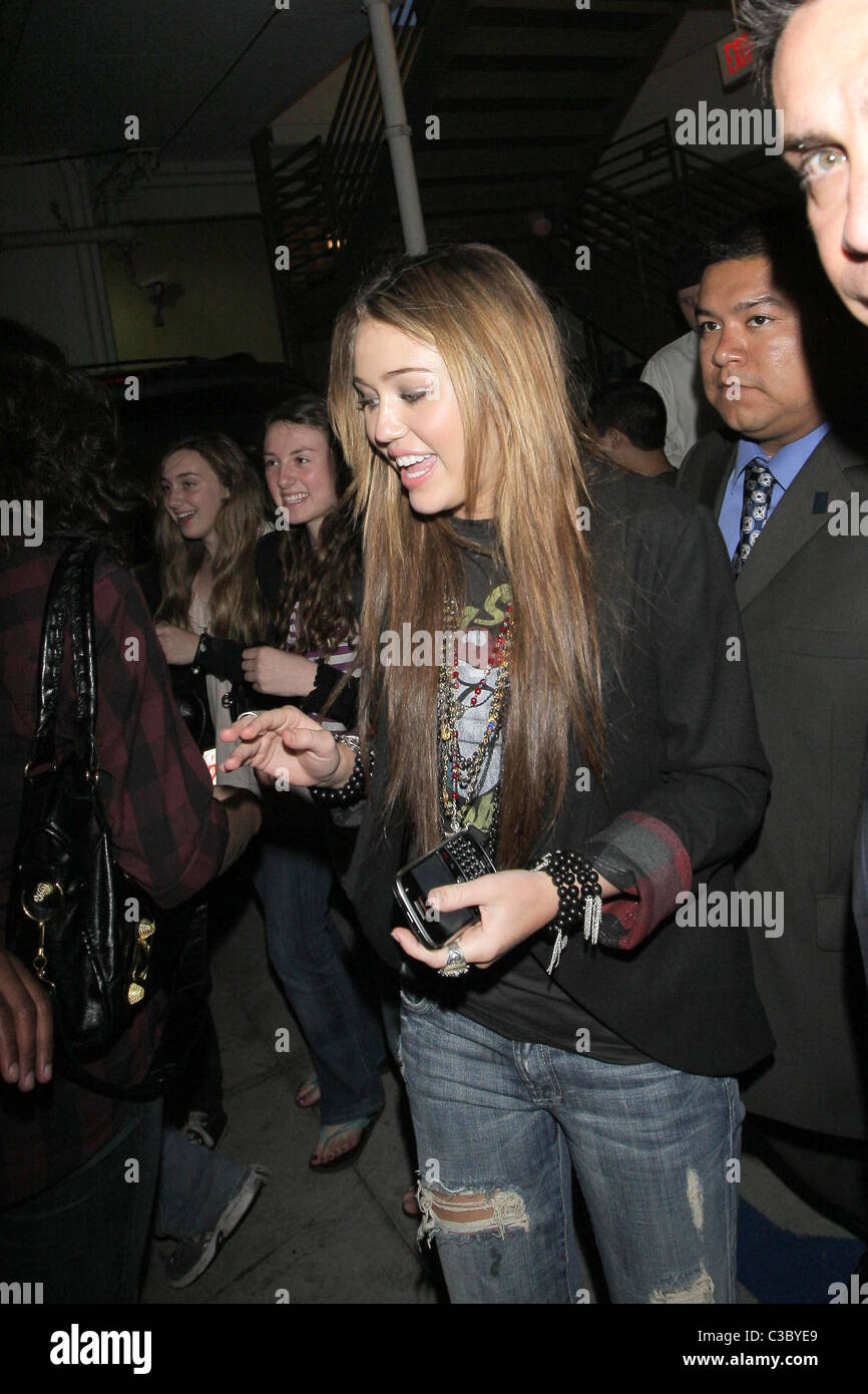 Miley Cyrus is mobbed by fans asking for autographs and photos with