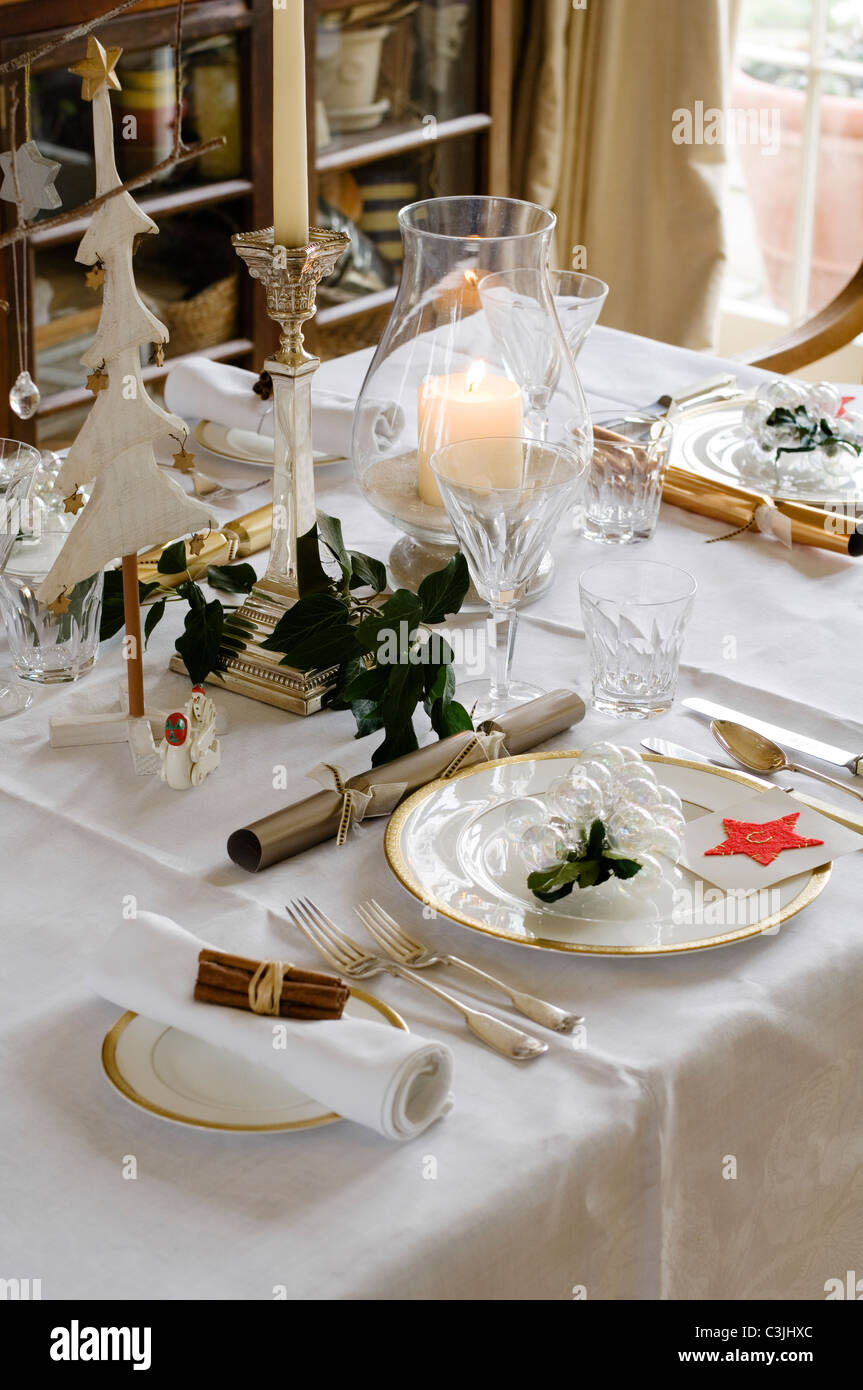Festive table place setting with crackers, candles and glassware ... Festive table place setting with crackers, candles and glassware ...