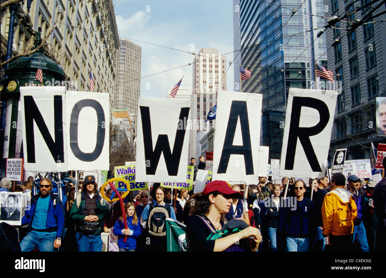 anti war demonstrators march with giant no war sign on market street