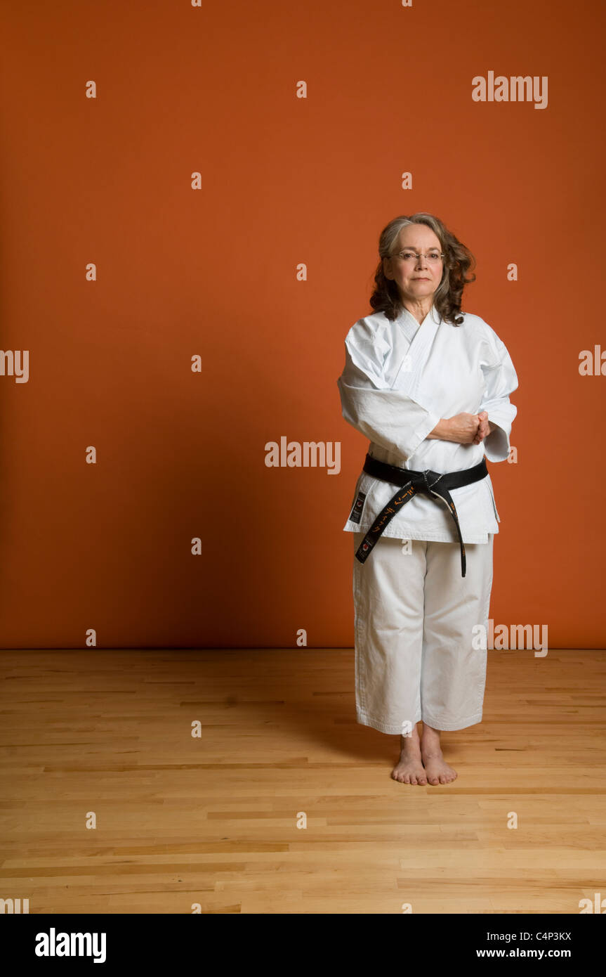Middleaged woman in karate uniform Stock Photo, Royalty Free Image