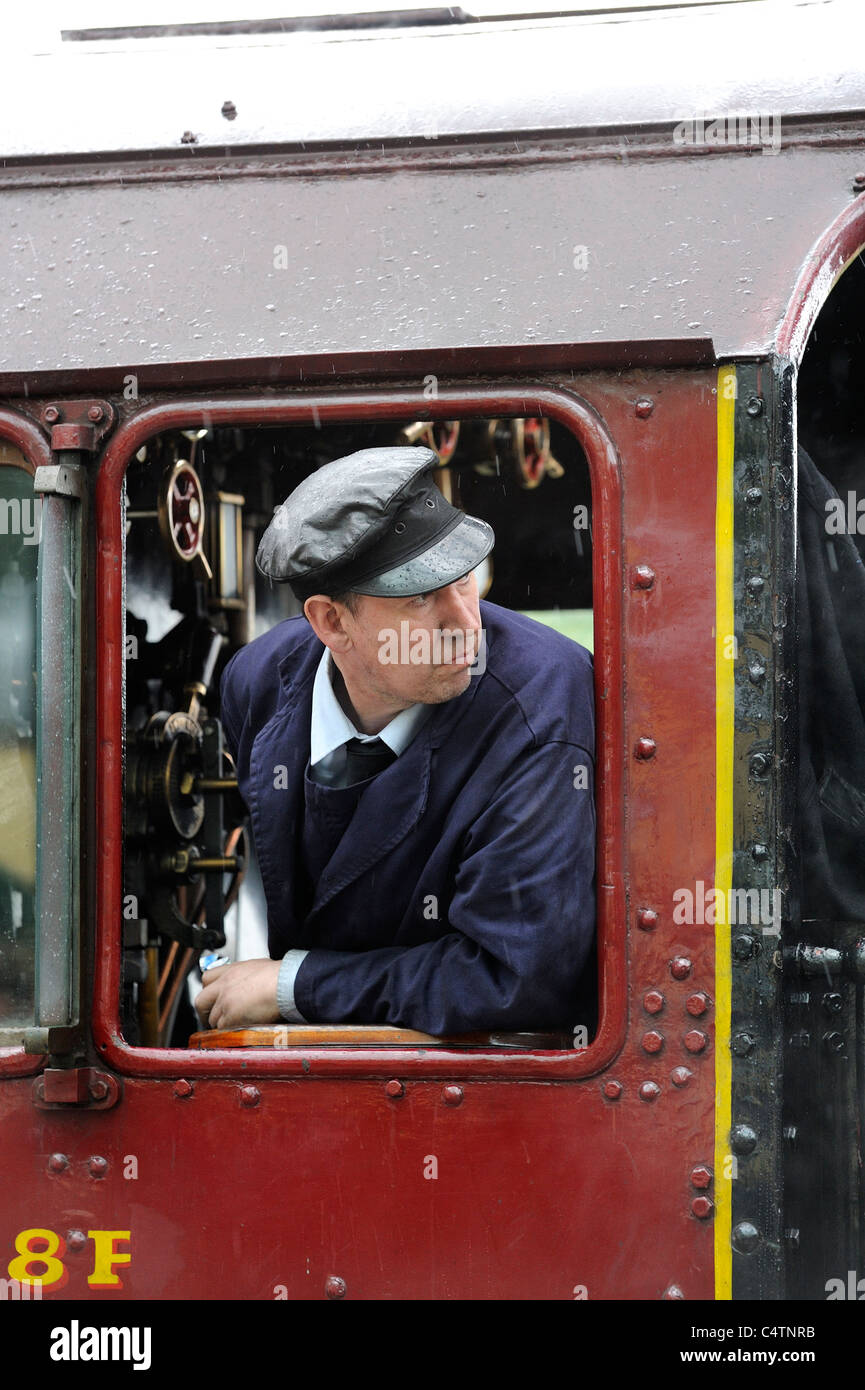 Steam train driver on the great central railway Stock Photo
