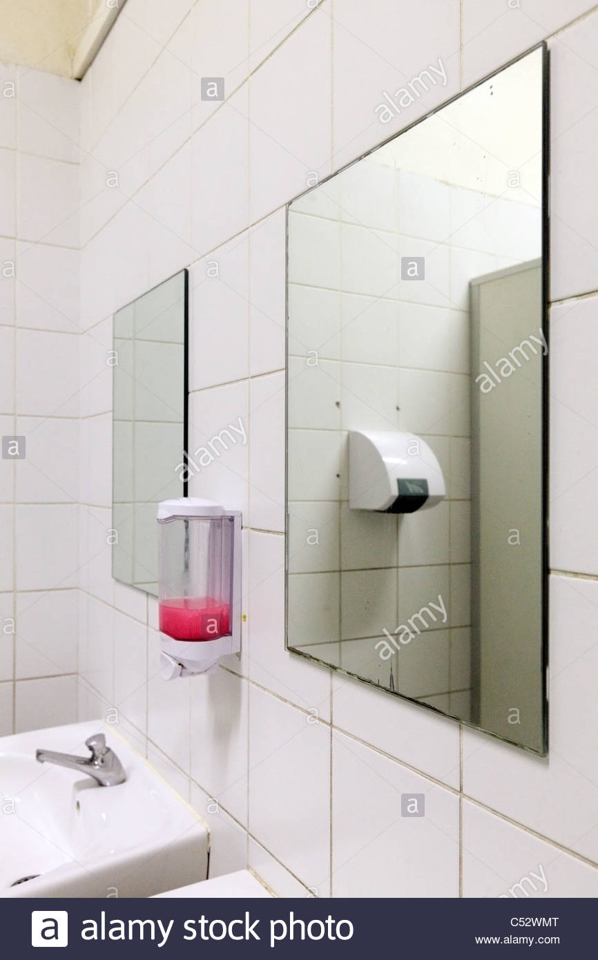 Public Bathroom Sink mirror sink and soap dispenser in a public bathroom stock photo Public Bathroom Sink mirror sink and soap dispenser in a public bathroom stock photo