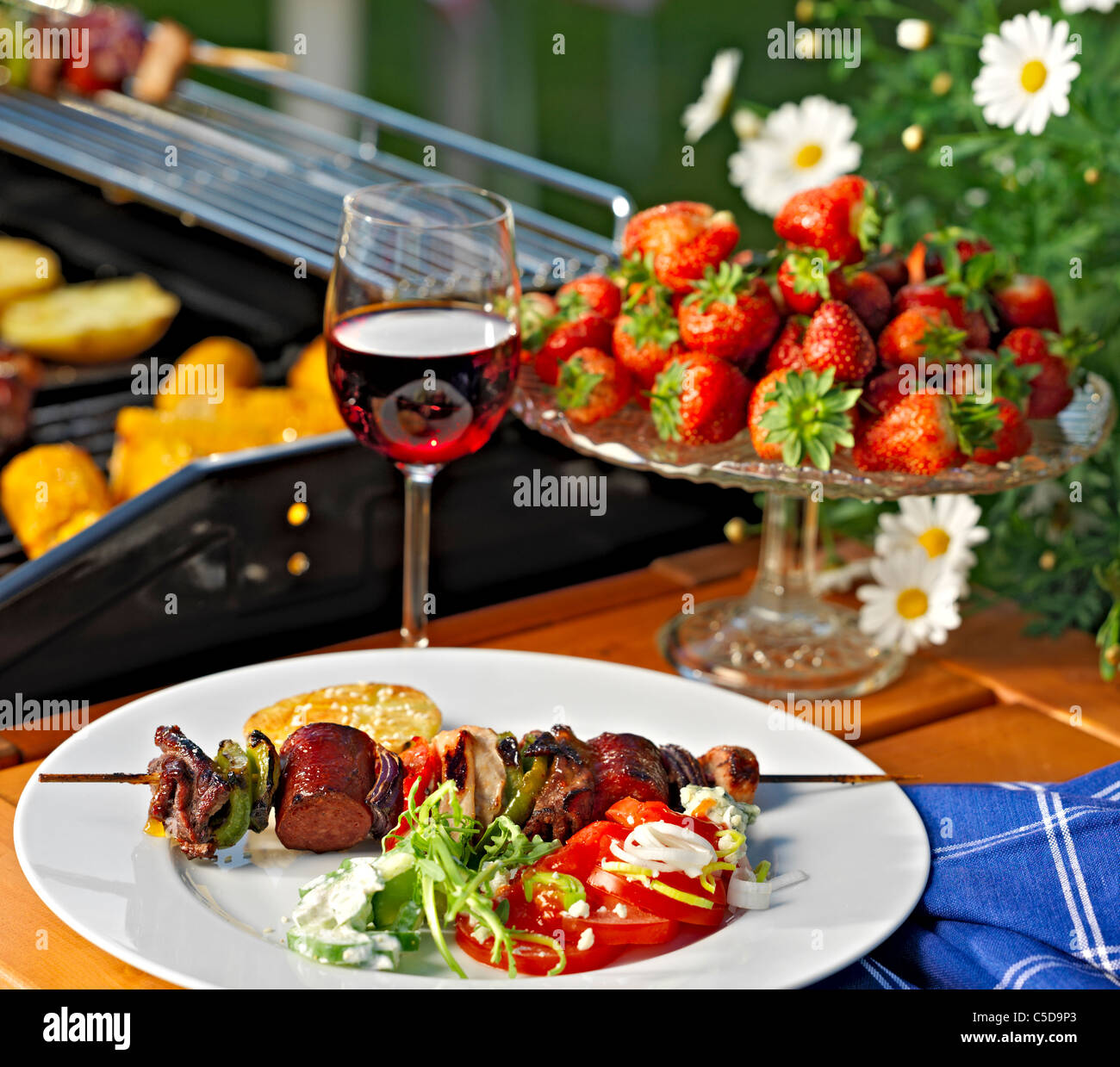 Skewers In Plate With Wine Glass And Strawberries At The Backyard