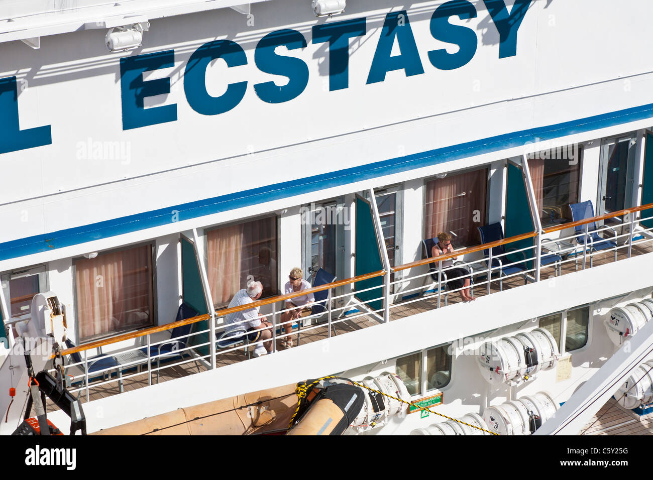 Cruise ship passengers on balconies of Carnival Ecstasy cruise ship