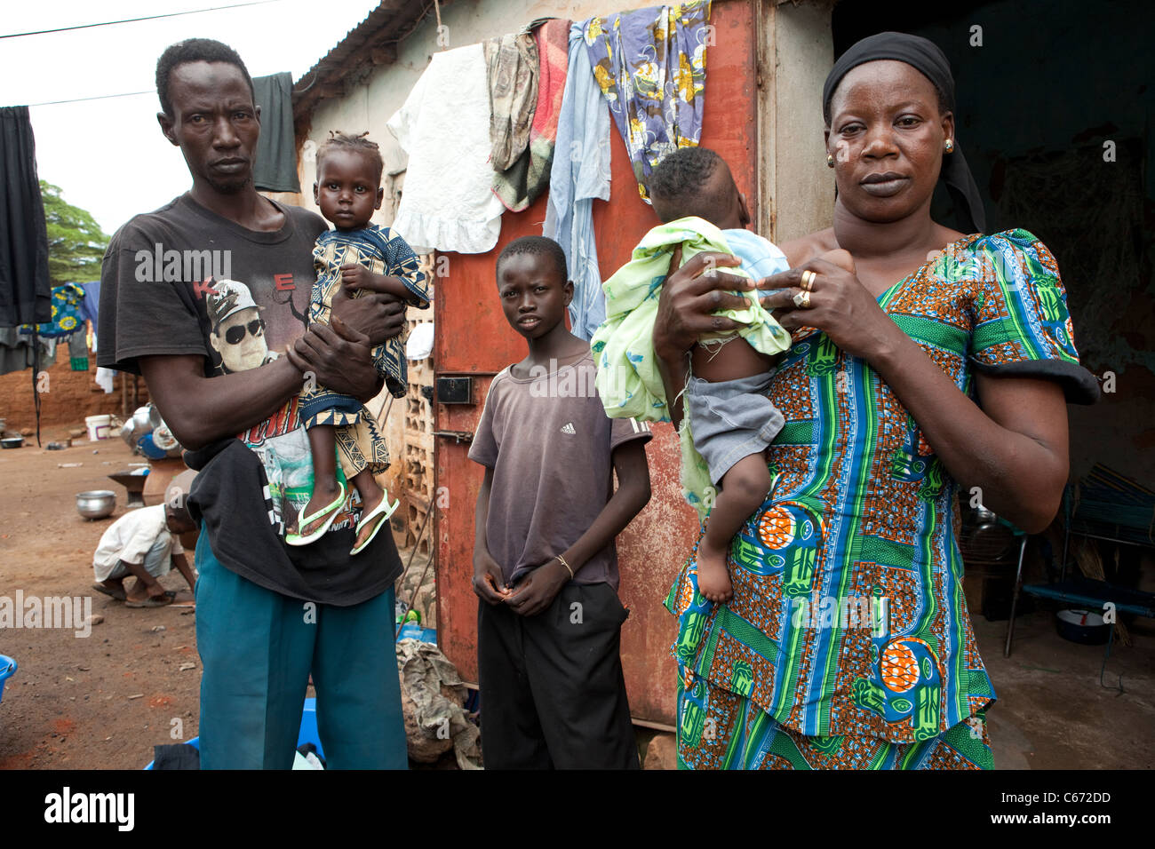 A family stands outside their house in a slum in Bamako, Mali, West