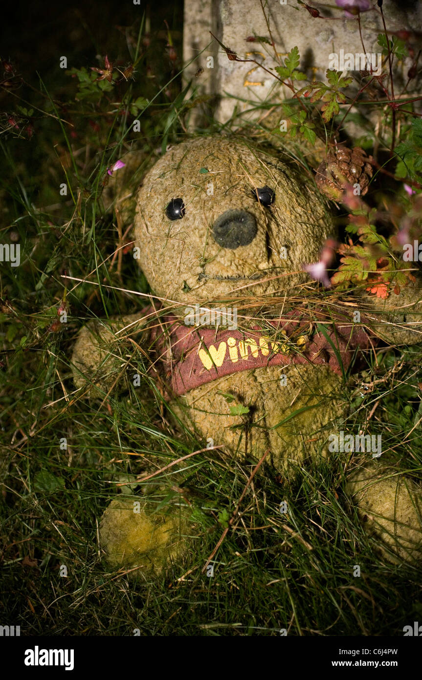 rotting stuffed toy in a children's graveyard Stock Photo, Royalty Free