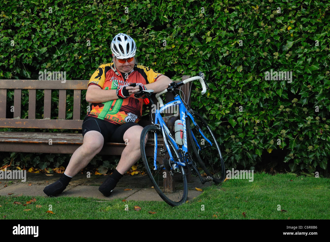 obese-cyclist-having-a-rest-and-using-mo